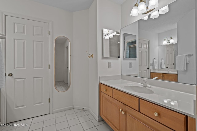 bathroom featuring baseboards, vanity, and tile patterned flooring