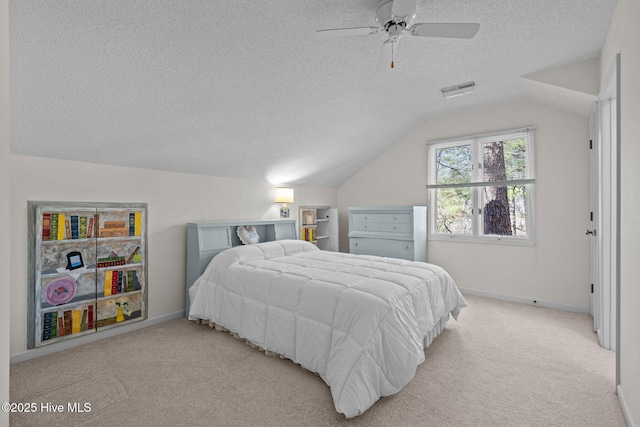 carpeted bedroom featuring vaulted ceiling, baseboards, visible vents, and a textured ceiling