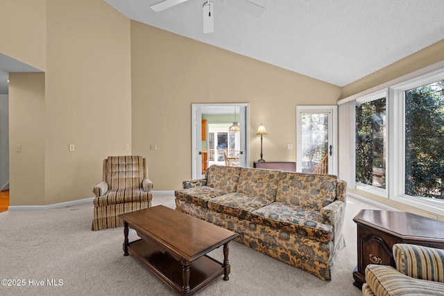 carpeted living area featuring ceiling fan, high vaulted ceiling, and baseboards