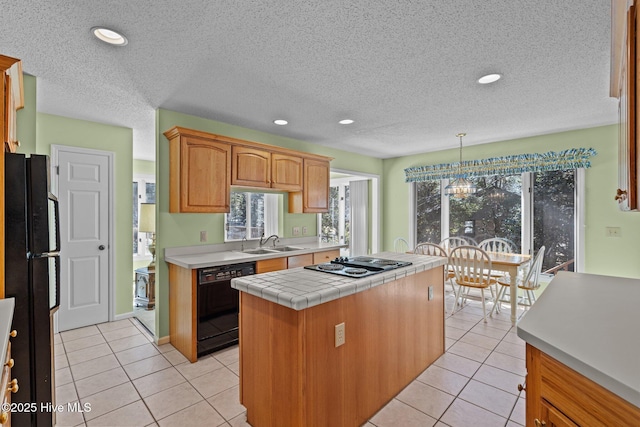 kitchen featuring black appliances, light tile patterned flooring, recessed lighting, and a sink