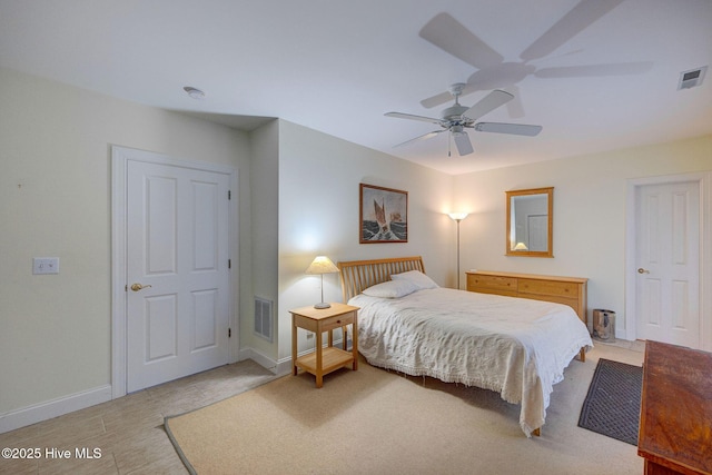 bedroom with baseboards, visible vents, and a ceiling fan