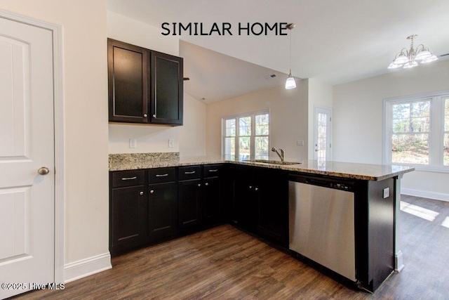 kitchen featuring dark wood-style flooring, dishwasher, a peninsula, and a sink