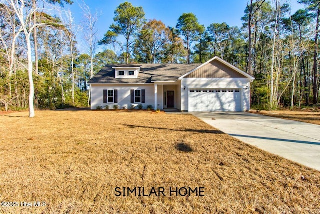 view of front of home with a front lawn, driveway, and an attached garage