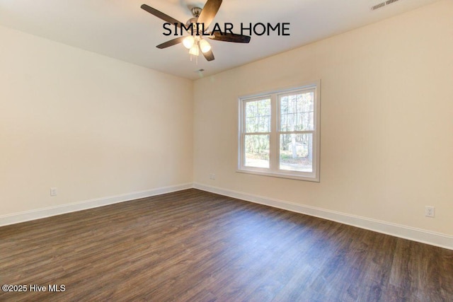 empty room featuring dark wood-style flooring, visible vents, ceiling fan, and baseboards