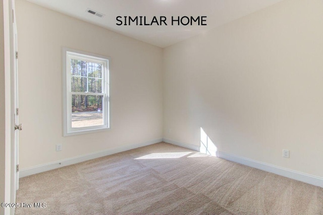 carpeted empty room with visible vents and baseboards