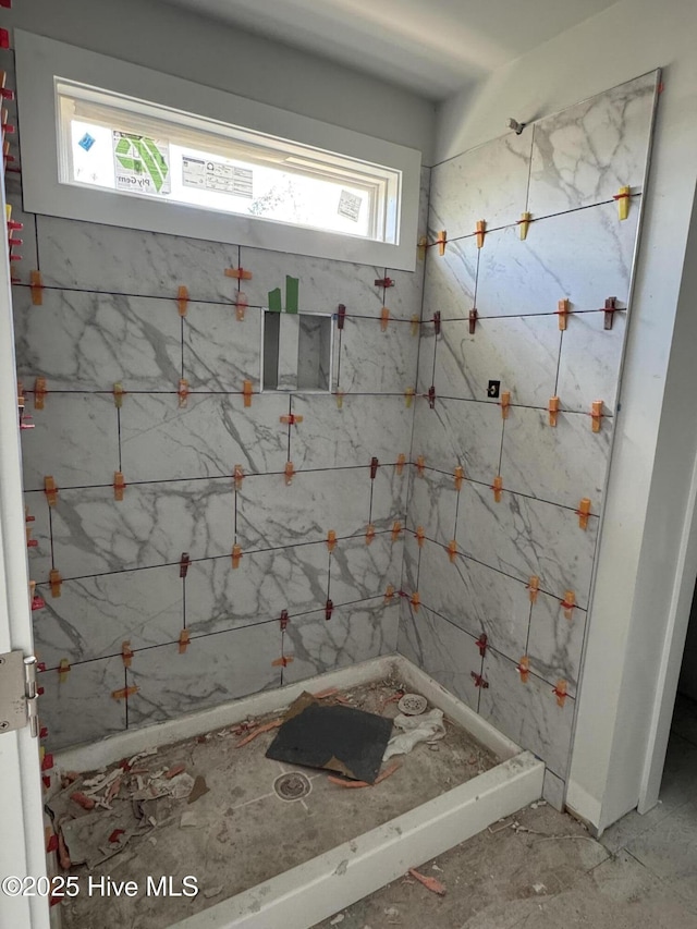 bathroom with a tile shower