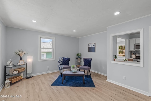 living area with a wealth of natural light, light wood finished floors, and baseboards