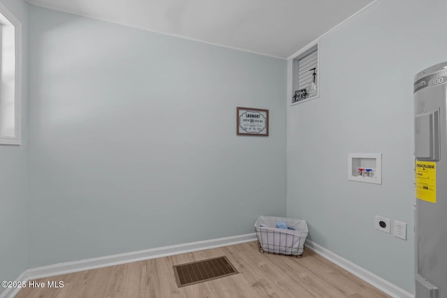 laundry room with electric dryer hookup, visible vents, washer hookup, wood finished floors, and laundry area