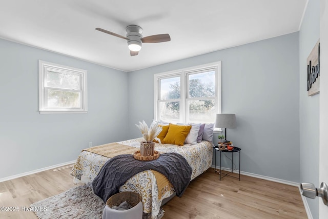 bedroom featuring a ceiling fan, wood finished floors, and baseboards