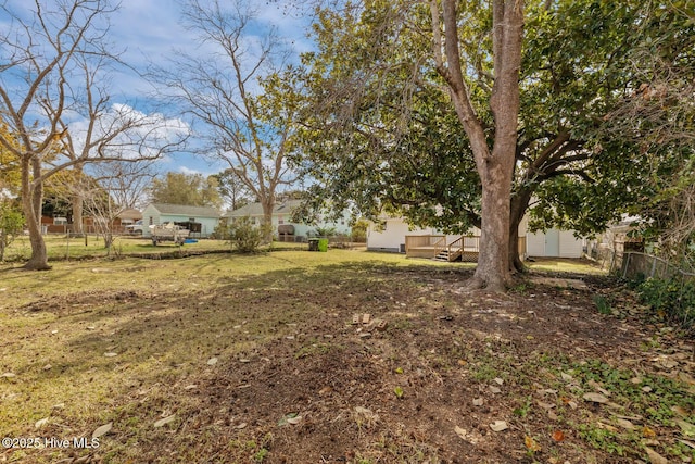 view of yard featuring fence and a wooden deck