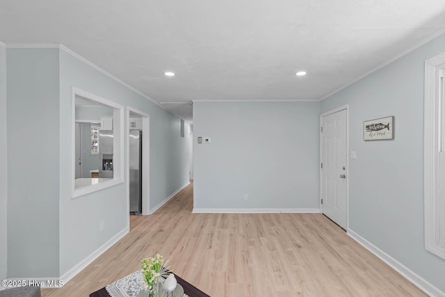 interior space with wood finished floors, baseboards, and ornamental molding