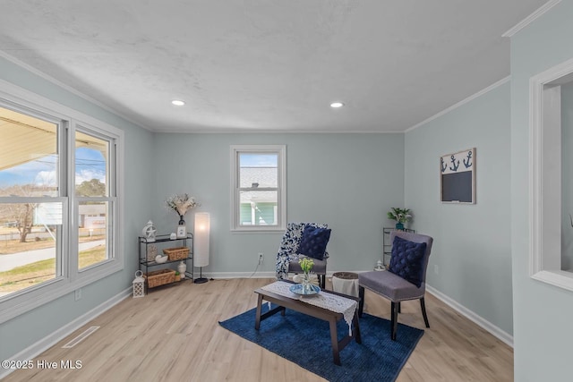 sitting room featuring crown molding, baseboards, and wood finished floors