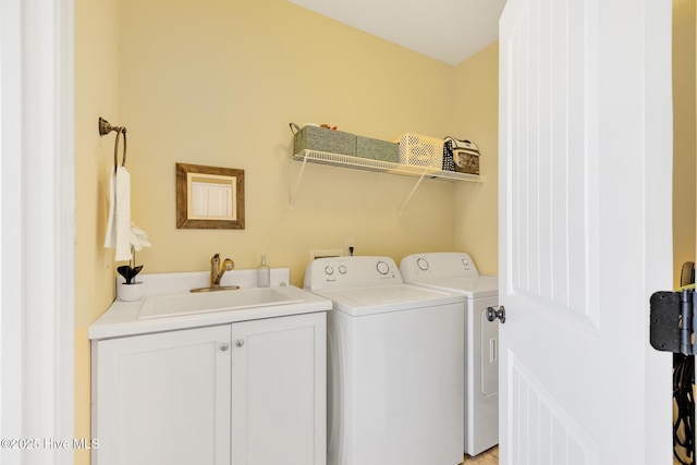 laundry room featuring a sink, cabinet space, and washer and clothes dryer