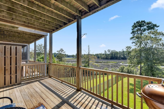 wooden deck featuring a yard