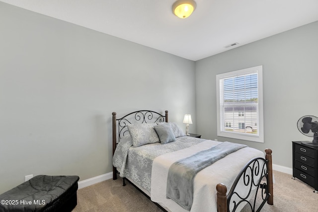 bedroom with light colored carpet, visible vents, and baseboards