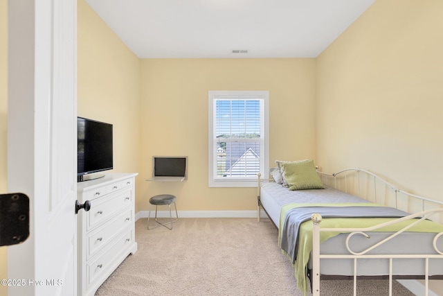 bedroom featuring light colored carpet, visible vents, and baseboards