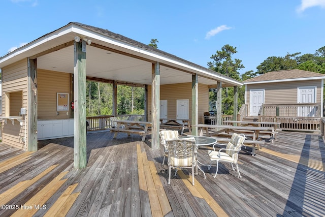 wooden terrace featuring outdoor dining area