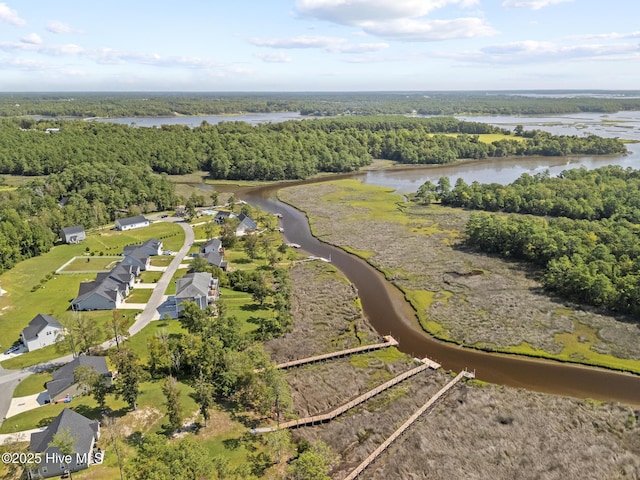 drone / aerial view with a view of trees and a water view