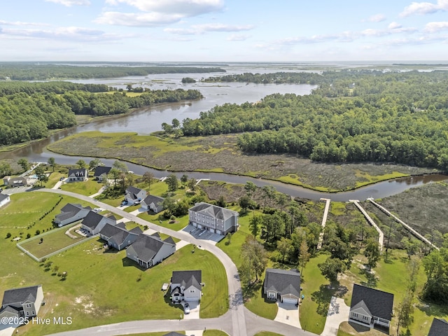 aerial view with a residential view, a view of trees, and a water view