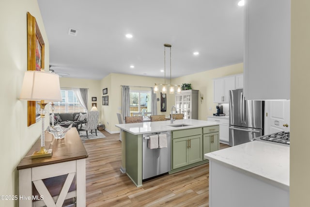 400 Frida Rd, New Bern, NC 28560 - kitchen featuring stainless steel appliances, green cabinets, a sink, plenty of natural light, and recessed lighting