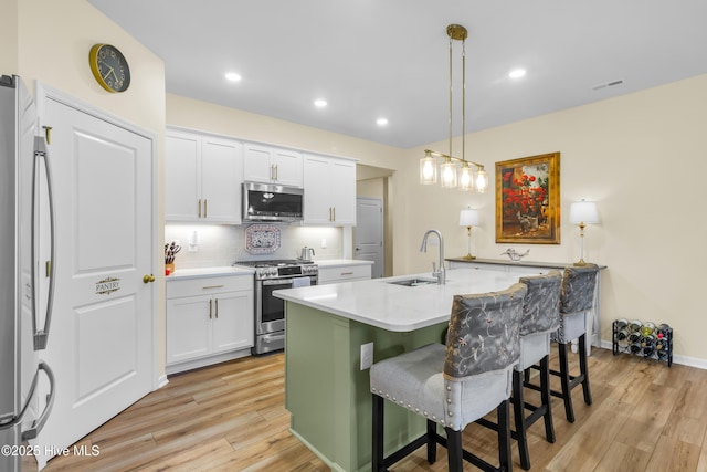 400 Frida Rd, New Bern, NC 28560 - kitchen featuring appliances with stainless steel finishes, a sink, light wood-style floors, white cabinetry, and recessed lighting