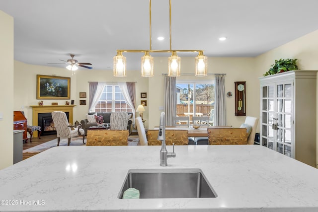 400 Frida Rd, New Bern, NC 28560 - kitchen featuring a sink, light stone countertops, open floor plan, decorative light fixtures, and a ceiling fan
