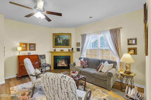400 Frida Rd, New Bern, NC 28560 - living area with a ceiling fan, baseboards, a glass covered fireplace, and wood finished floors