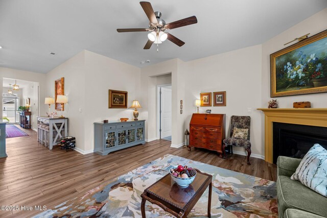 400 Frida Rd, New Bern, NC 28560 - living area featuring wood finished floors, a ceiling fan, a fireplace, and baseboards