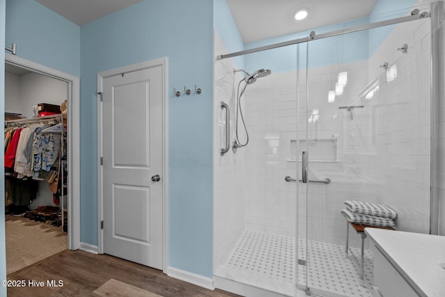 400 Frida Rd, New Bern, NC 28560 - bathroom with a stall shower, wood finished floors, a spacious closet, and vanity