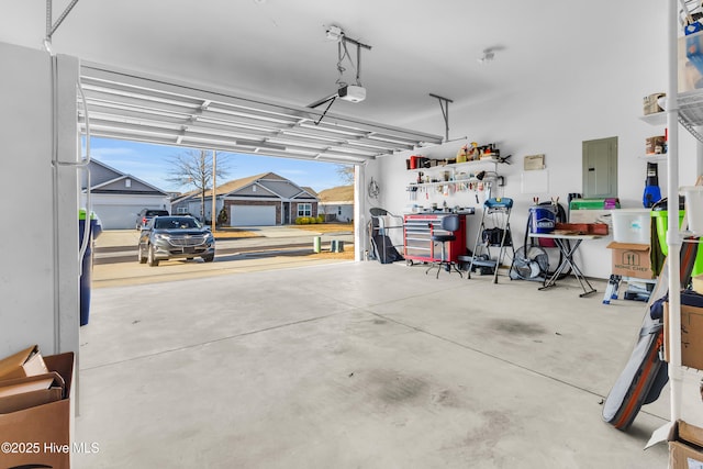 400 Frida Rd, New Bern, NC 28560 - garage featuring electric panel, freestanding refrigerator, and a garage door opener