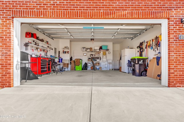 400 Frida Rd, New Bern, NC 28560 - garage with freestanding refrigerator and a workshop area