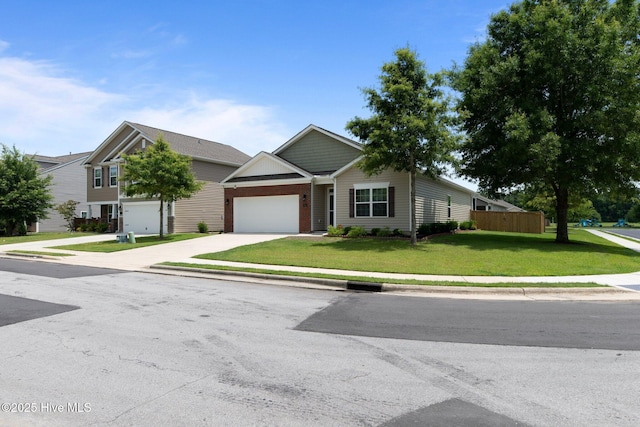 400 Frida Rd, New Bern, NC 28560 - view of front of home with a garage, concrete driveway, a front lawn, and brick siding