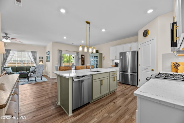 400 Frida Rd, New Bern, NC 28560 - kitchen featuring appliances with stainless steel finishes, a sink, open floor plan, green cabinetry, and light wood finished floors