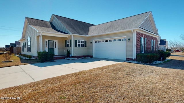 view of front of property with driveway, a front lawn, roof with shingles, and an attached garage