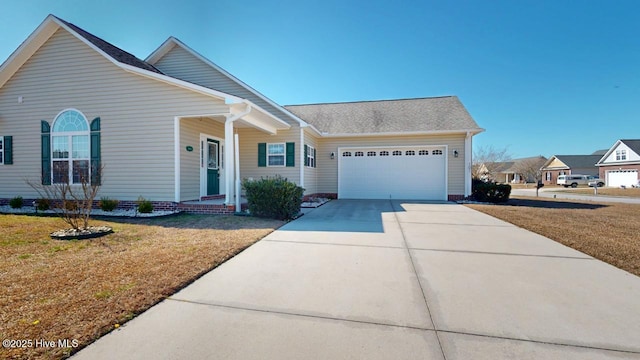 view of front of house with driveway, an attached garage, and a front yard