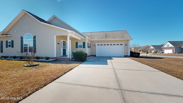 view of front of property featuring a front lawn, concrete driveway, and a garage