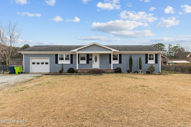 ranch-style house with driveway, an attached garage, fence, a front yard, and brick siding