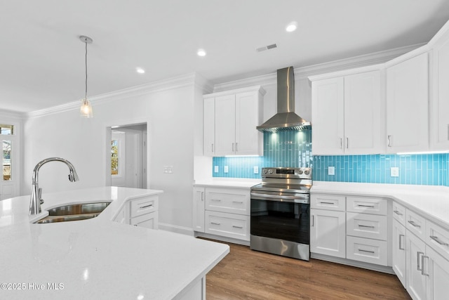 7105 E Yacht Dr, Oak Island, NC 28465 - kitchen featuring wall chimney range hood, stainless steel electric range oven, wood finished floors, white cabinetry, and a sink