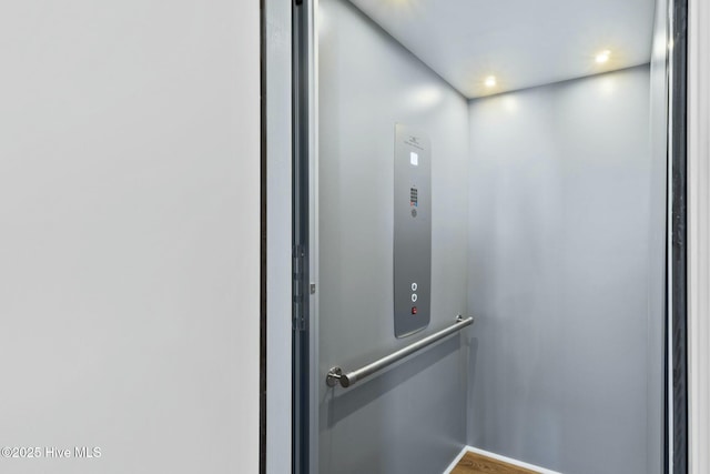 7105 E Yacht Dr, Oak Island, NC 28465 - elevator featuring recessed lighting and wood finished floors