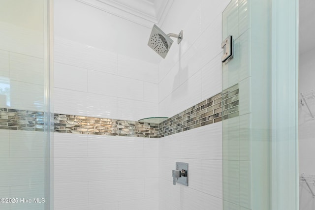 7105 E Yacht Dr, Oak Island, NC 28465 - interior details with a walk in closet, a tile shower, and ornamental molding