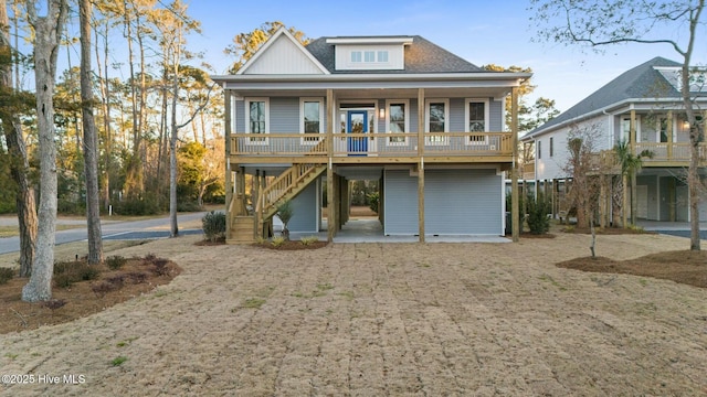 back of property featuring a porch and stairs