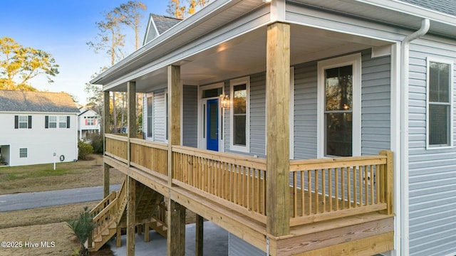 7105 E Yacht Dr, Oak Island, NC 28465 - wooden terrace featuring a porch
