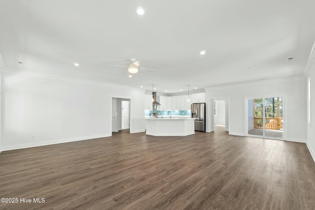 7105 E Yacht Dr, Oak Island, NC 28465 - unfurnished living room featuring ornamental molding, dark wood finished floors, recessed lighting, baseboards, and ceiling fan