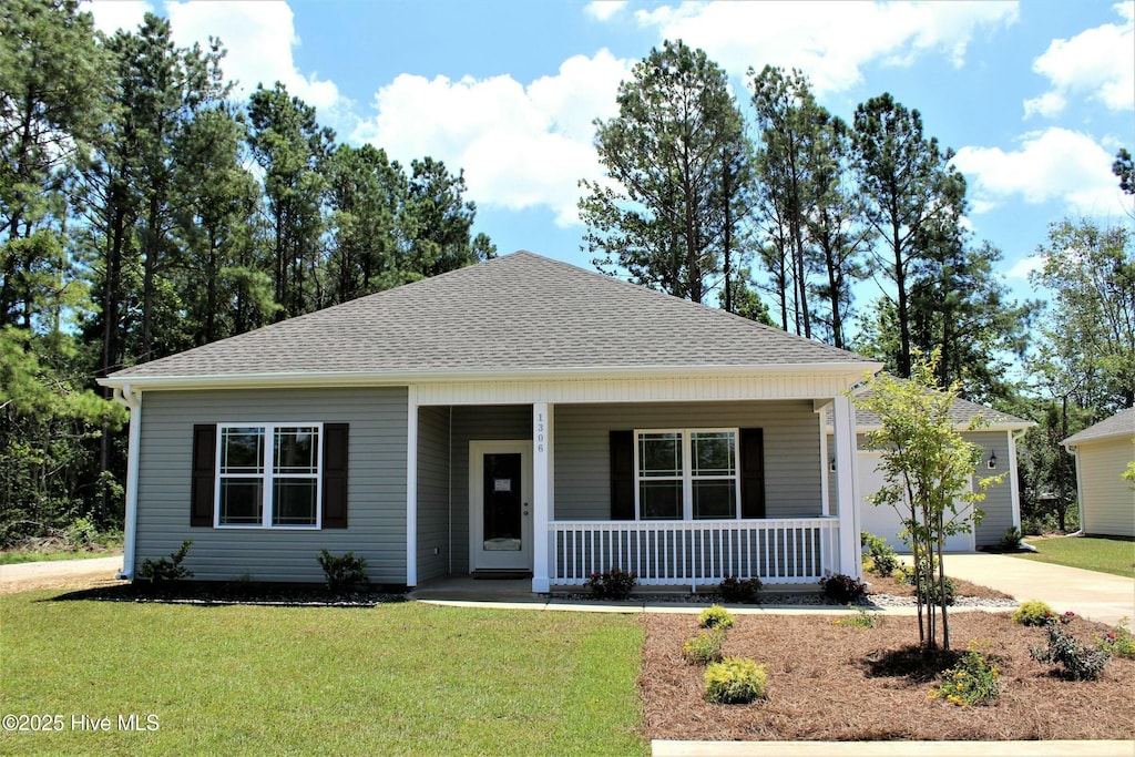 view of front facade featuring a porch, concrete driveway, a front yard, a shingled roof, and a garage