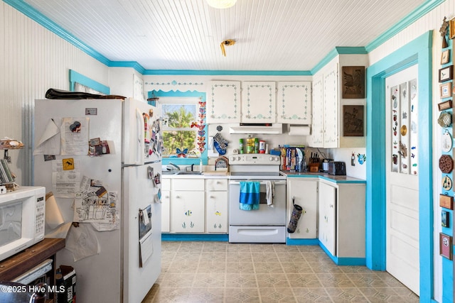 kitchen with white appliances, white cabinets, ornamental molding, light countertops, and under cabinet range hood