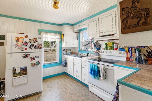 kitchen featuring light countertops, white cabinets, a sink, white appliances, and under cabinet range hood