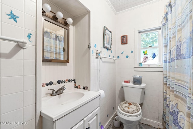 full bath featuring toilet, ornamental molding, vanity, and tile walls