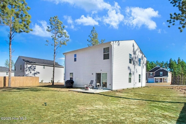 back of property with a patio area, fence, and a yard