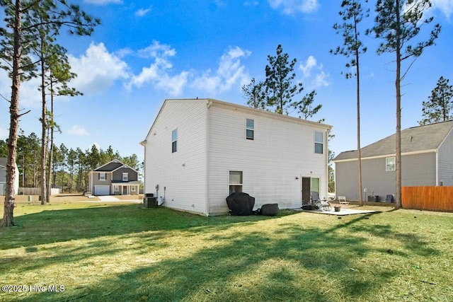 rear view of house with a patio, central AC unit, a lawn, and fence