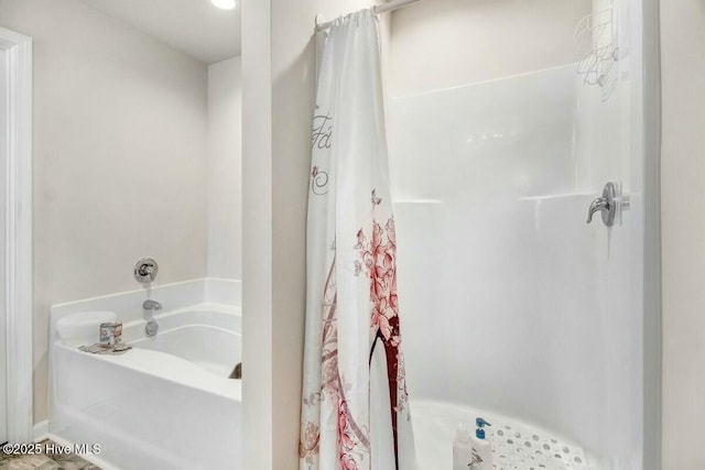 bathroom featuring a tub to relax in and curtained shower